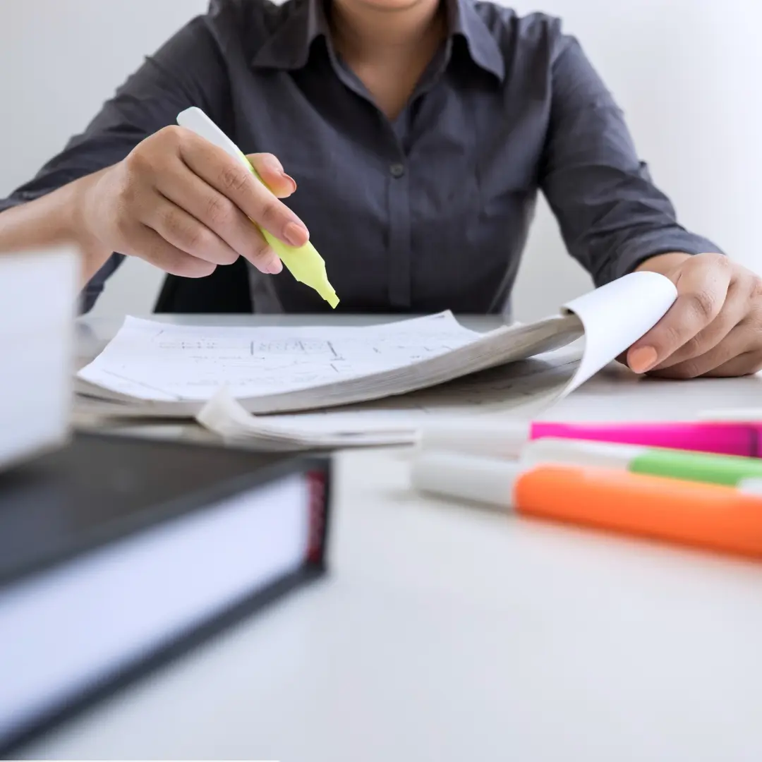 Person highlighting papers