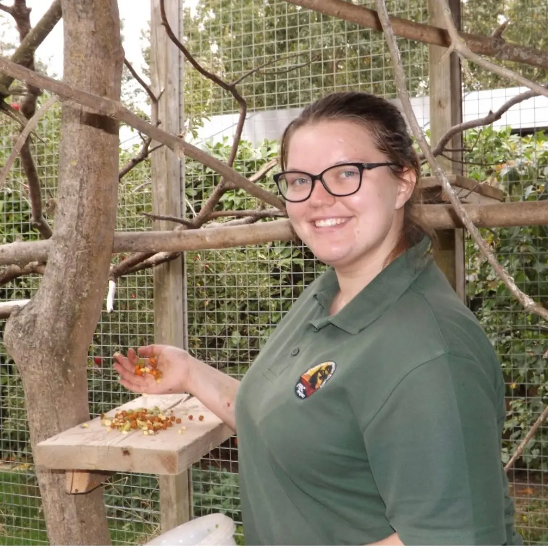 girl smiling at zoo wearing green