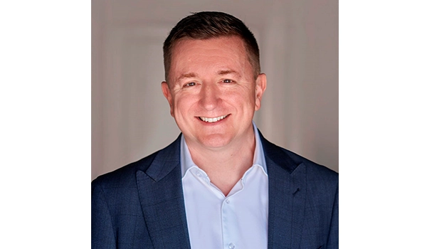 man smiling at camera in blue suit