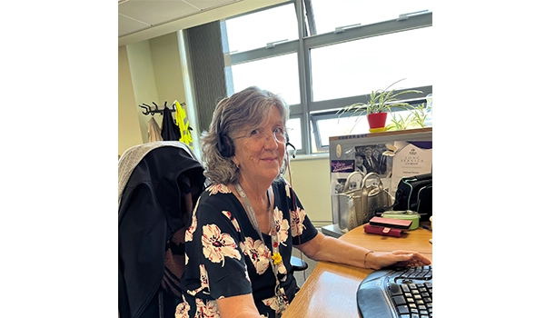 lady at desk looking at camera