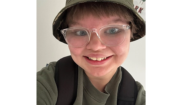 lady with glasses smiling at camera