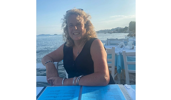 lady in the sunshine smiling at camera