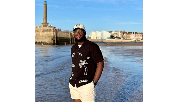 man standing on the beach with his hands in his pocket