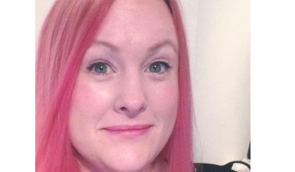 girl with pink hair smiling