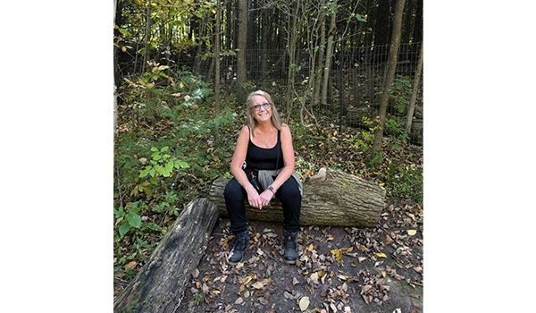 lady sitting on a tree trunk