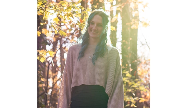 girl smiling infront of tree