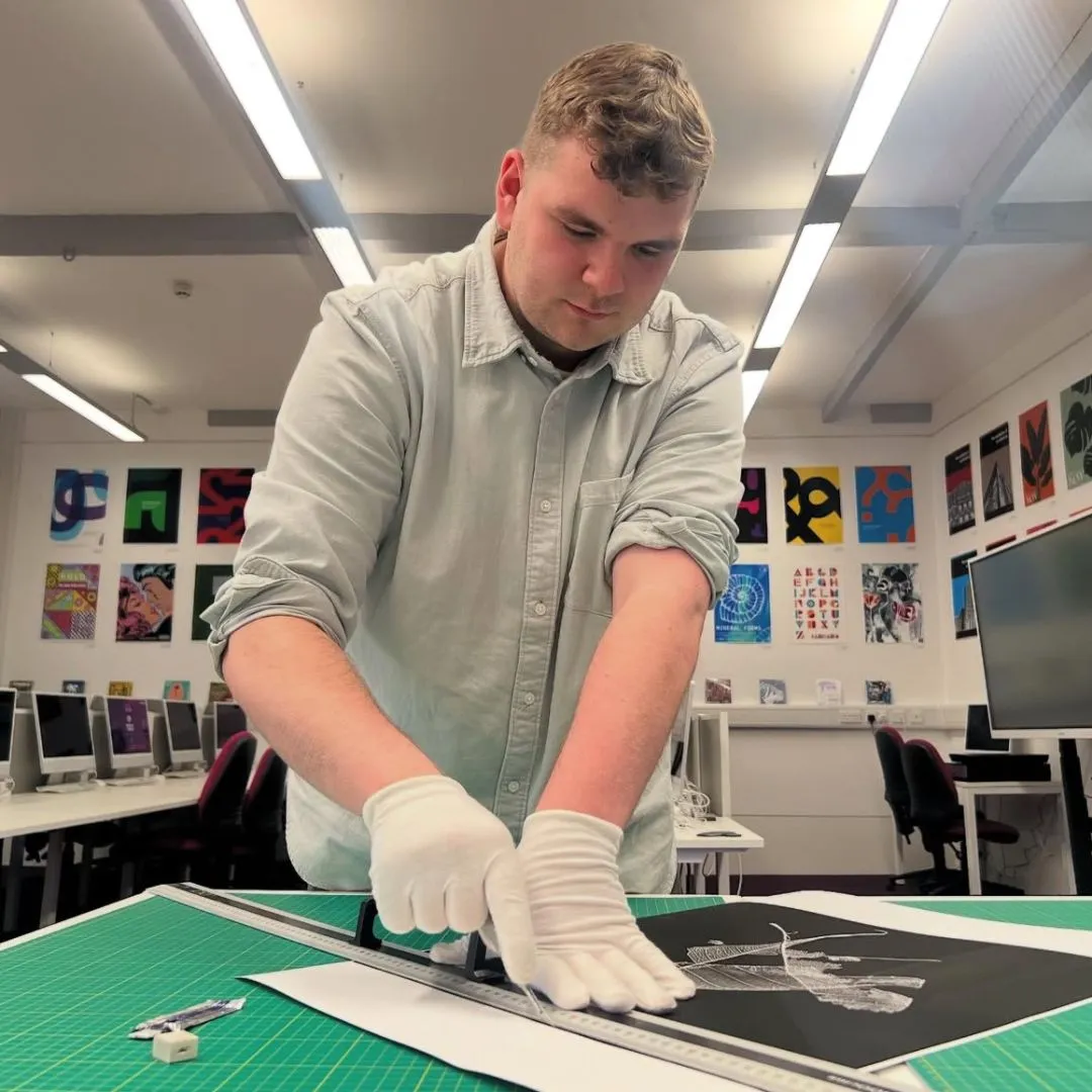 Student focusing on artwork