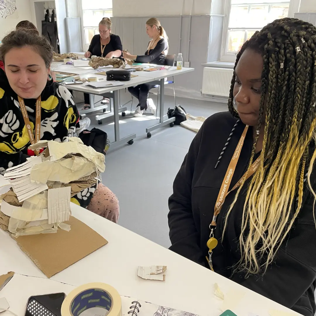 Two students working on paper mache model