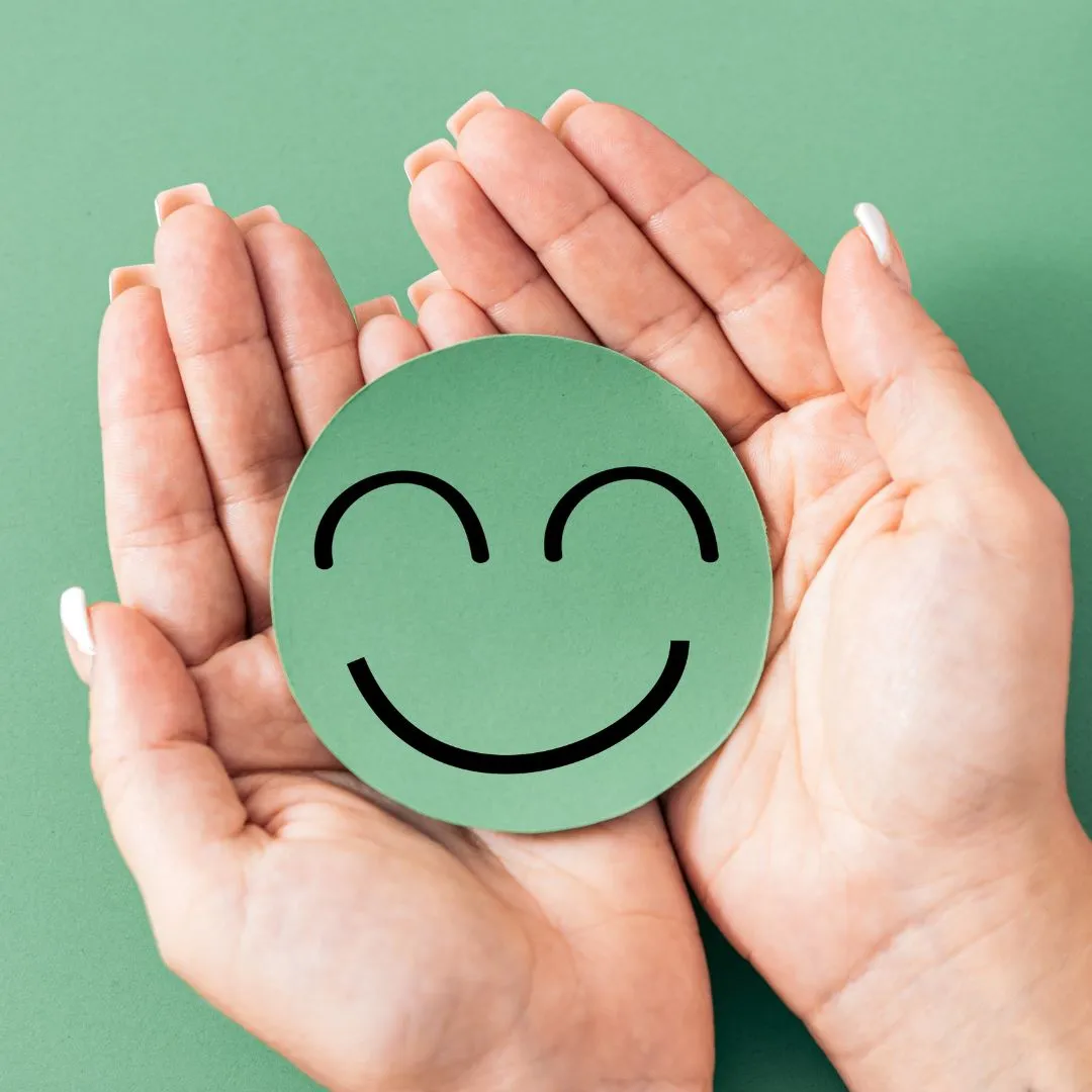 Hands holding a smiley face