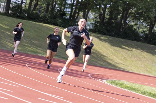 Sport students running on track