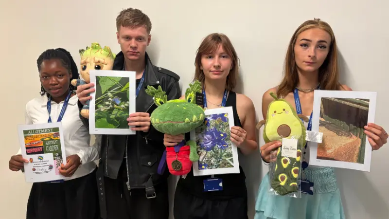 Four Level 1 Progression students with their photographs, certificates and prizes