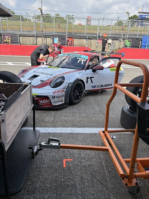 Students in pit lane with racing car at Brands Hatch