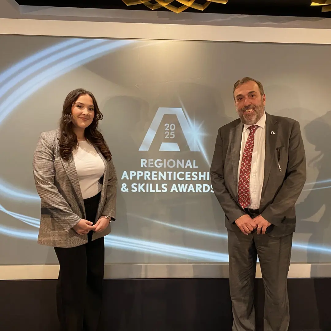 Pictured Maddie left in front of presentation with Nabil on right.