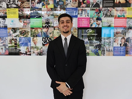 student posing in corridor