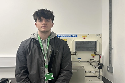 Sunny smiling at the camera in the engineering room