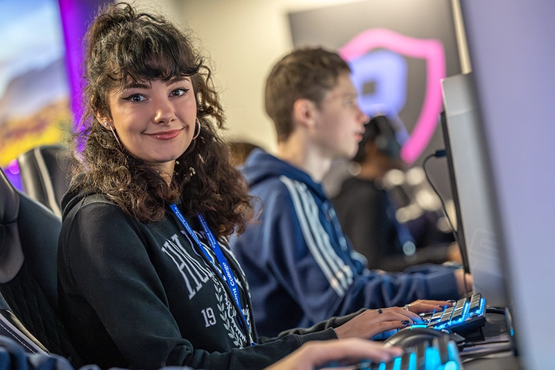 Student smiling while using keyboard in the IT room