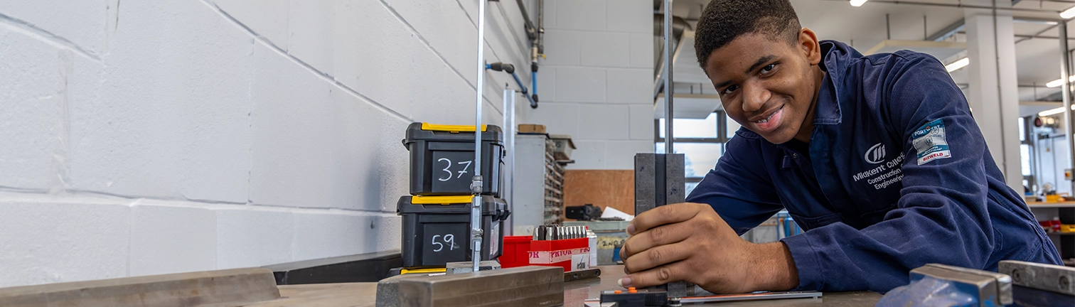 Engineering student working on a machine