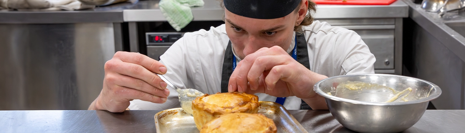 Hospitality student looking at pie
