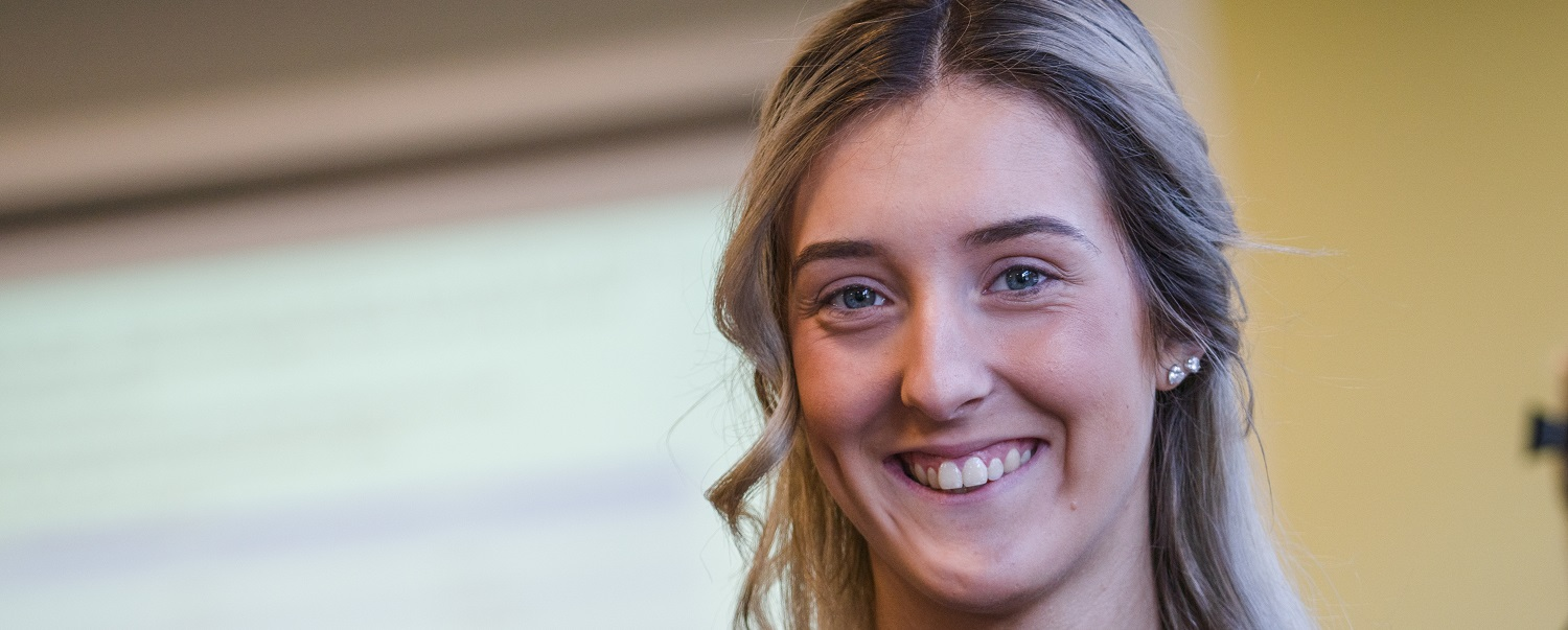 Hairdressing student smiles at the camera