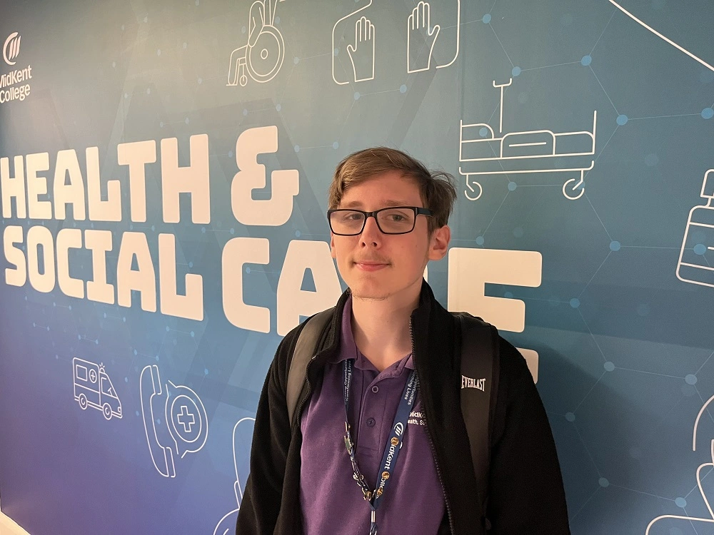 Student posing in corridor