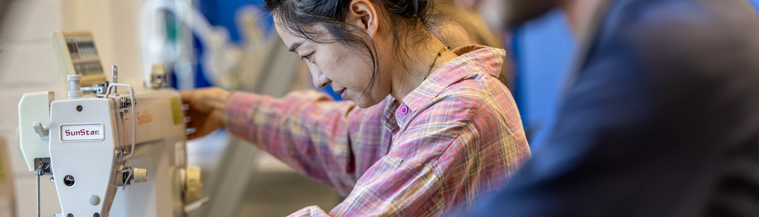 Student working on sewing machine