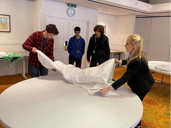 students laying tables