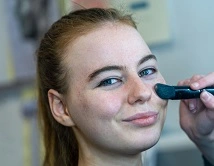 A student having make up applied