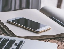 A phone on top of a notebook