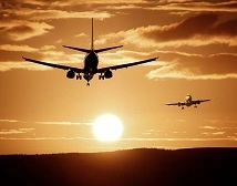 Planes flying into a sunset